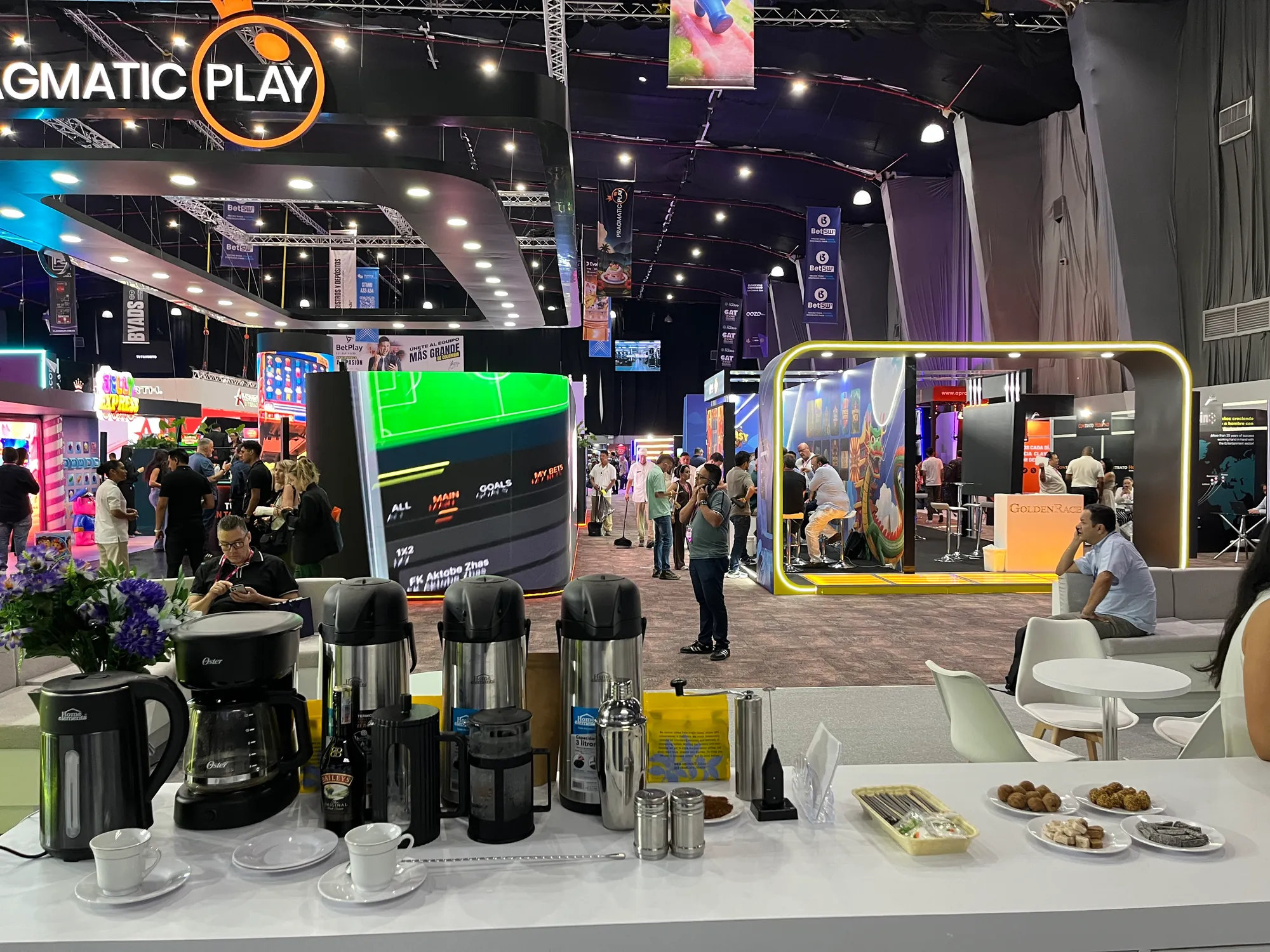 Coffee station counter with thermoses, coffee makers, cups and cookies on a trade show floor in Cartagena