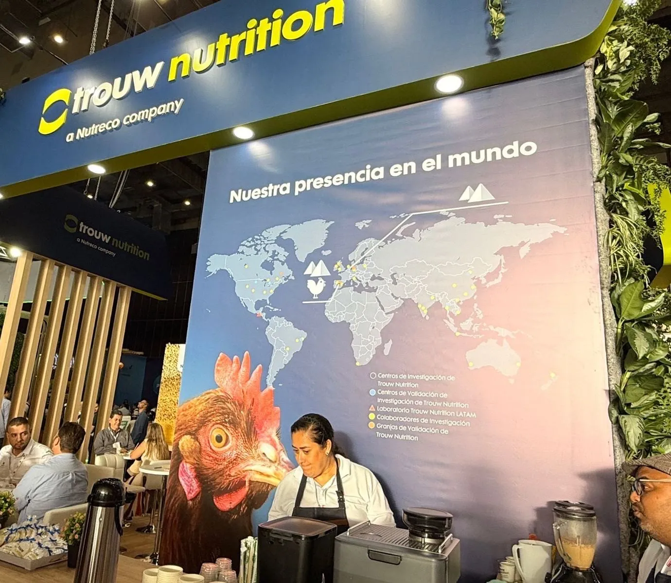 Barista de Experiencia VINTO preparando bebidas en la barra de café del stand de Trouw Nutrition durante una feria empresarial en Cali