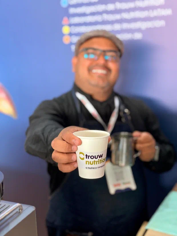 Barista de Experiencia VINTO entrega un vaso de café personalizado con la marca del cliente en un evento en Cali